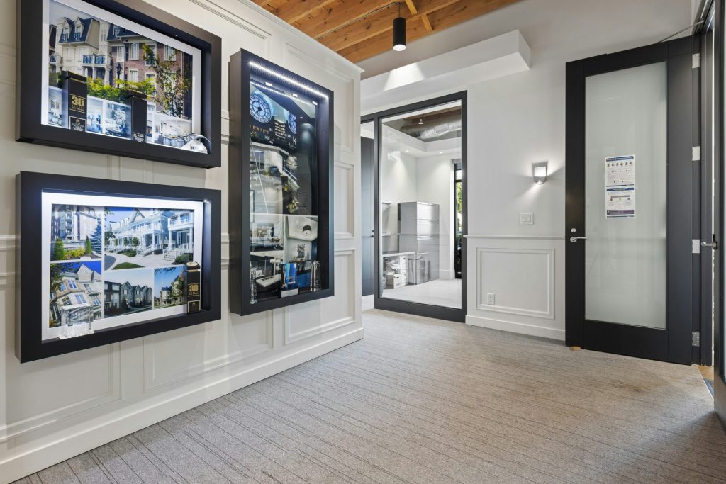 a room with several framed pictures